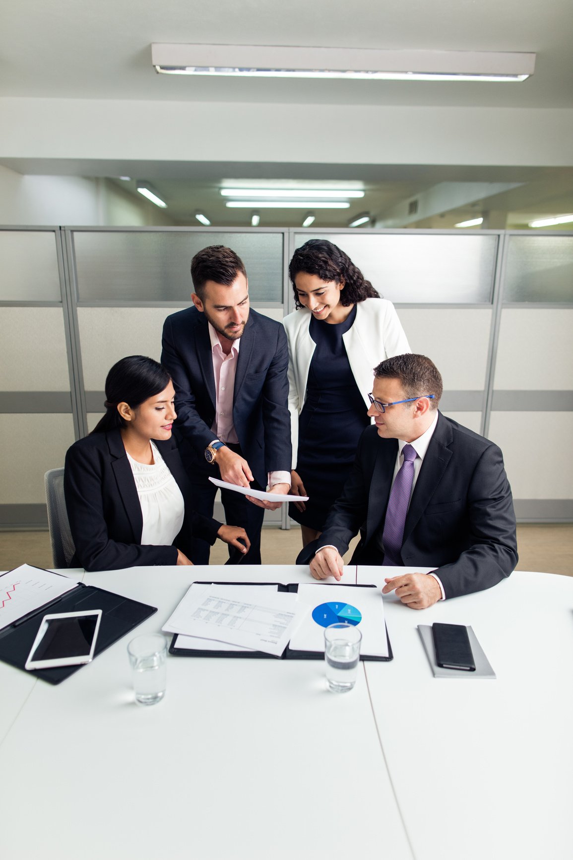 Latin executives looking at document during meeting